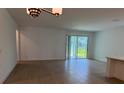 Bright living room with sliding glass doors and wood-look tile flooring at 2560 Cavanaugh Dr, Orlando, FL 32817