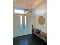 Bright entryway with dark hardwood floors, bench, and modern light fixture at 816 Johns Point Dr, Oakland, FL 34787