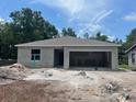 New single-story home featuring an attached garage on a spacious lot ready for finishing at 1608 Jefferson Dr, Mount Dora, FL 32757