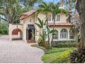 Charming two-story home showcases a red tile roof, arched windows, and porte cochere entrance at 732 Edgewater Dr, Orlando, FL 32804