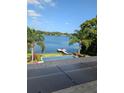 Stunning backyard features a pool, lush lawn, private dock, and serene lake views, creating an ideal outdoor retreat at 1010 Strathmore Dr, Orlando, FL 32806