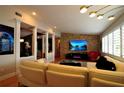Open living room with stone accent wall, a sleek media center, and elegant lighting at 1010 Strathmore Dr, Orlando, FL 32806