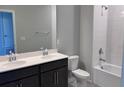 Bathroom with a double sink vanity, a large mirror, and a shower-tub combo at 1181 Basalt Ln, Sanford, FL 32771