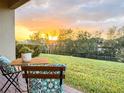 Outdoor seating area with beautiful sunset views overlooking green grass at 886 Grazie Loop, Davenport, FL 33837