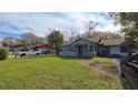 House exterior showcasing a walkway to the front door and a spacious yard at 3408 Lewis Ct, Orlando, FL 32805