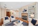 Bright living room with hardwood floors, fireplace, built-in shelves, and stylish furnishings at 1223 Country Club Oaks Cir, Orlando, FL 32804