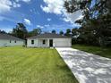 Beautiful single-story home featuring a manicured lawn, a paved driveway, and an attached garage at 282 Kimble Ave, Oviedo, FL 32765