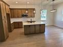 A kitchen with stainless steel appliances, island and wood-look tile flooring at 282 Kimble Ave, Oviedo, FL 32765