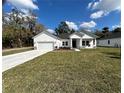 Inviting single-story home with a pristine lawn, ample parking, and a welcoming entrance at 292 Kimble Ave, Oviedo, FL 32765