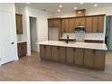 Open concept kitchen featuring stainless steel appliances, a large island, and plenty of cabinet space at 292 Kimble Ave, Oviedo, FL 32765