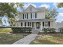 Two-story house with a front porch and landscaped yard at 1020 Wisconsin Ave, Saint Cloud, FL 34769