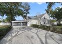 Two-story house with carport and paved driveway at 1020 Wisconsin Ave, Saint Cloud, FL 34769