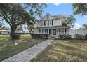 Two-story house with a front porch and landscaped yard at 1020 Wisconsin Ave, Saint Cloud, FL 34769