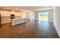 Open-concept living space featuring tile floors, ample natural light, and access to the backyard at 14771 Erice Ave, Clermont, FL 34714
