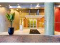 Inviting condo building entrance featuring colorful mosaic columns and modern glass doors at 155 S Court Ave # 2710, Orlando, FL 32801