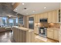 Open concept kitchen with stainless steel appliances, granite countertops, and breakfast bar overlooking the living area at 155 S Court Ave # 2710, Orlando, FL 32801