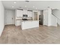 Open-concept kitchen with white cabinets, stainless steel appliances, and a granite countertop island at 4308 Ranch House Rd, Saint Cloud, FL 34772