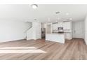 Bright open-concept living room featuring hard-wood floors and white walls at 4320 Ranch House Rd, Saint Cloud, FL 34772