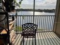 Enjoy the gorgeous lake view from this inviting balcony with a comfortable chair at 1909 Summer Club Dr # 307, Oviedo, FL 32765