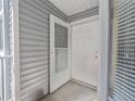 Inviting front entry featuring a storm door, white exterior, and neutral siding at 2246 Stonington Ave # 2246, Orlando, FL 32817