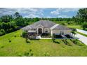 Attractive single-story home with lush landscaping, a screened porch, and pergola providing inviting outdoor living spaces at 18920 Overton St, Orlando, FL 32833