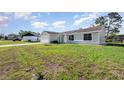 Charming single-story home with a well-maintained lawn and a two-car garage on a sunny day at 3186 Mapleshade St, Deltona, FL 32738