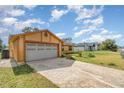 Spacious two-car garage with a patterned driveway and well-maintained lawn at 3186 Mapleshade St, Deltona, FL 32738