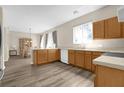 Kitchen features light wood cabinets, white appliances, and vinyl flooring at 525 Aster Dr, Davenport, FL 33897