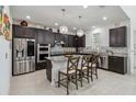 Modern kitchen with dark cabinets, granite counters, and stainless steel appliances at 720 Split Hoof Dr, Saint Cloud, FL 34771