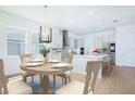 Bright kitchen and dining area features modern fixtures, and stainless steel appliances at 13163 Mcmillan Dr, Orlando, FL 32827