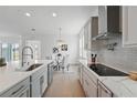 Modern kitchen featuring stainless steel appliances, quartz countertops, and tiled backsplash at 13163 Mcmillan Dr, Orlando, FL 32827