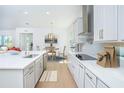 The gourmet kitchen features modern appliances, a stylish tile backsplash, and an adjacent dining area with natural light at 13163 Mcmillan Dr, Orlando, FL 32827