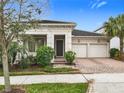 Inviting curb appeal of a home featuring a manicured lawn and a convenient two-car garage at 8325 Topsail Pl, Winter Garden, FL 34787