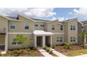 Townhome with well-maintained landscaping, neutral toned stucco, and stone accents at 2709 Scrapbook St, Kissimmee, FL 34746