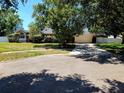 Charming home featuring a large garage and well-manicured lawn with mature trees, enhancing its curb appeal at 10161 Culpepper Ct, Orlando, FL 32836