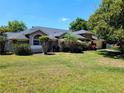 Beautiful home featuring a well-maintained lawn and vibrant landscaping, enhancing its curb appeal at 10161 Culpepper Ct, Orlando, FL 32836