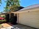Home featuring a large garage, arched entry and attractive landscaping at the entrance, enhancing its curb appeal at 10161 Culpepper Ct, Orlando, FL 32836