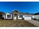Single-story home with stone accents and a two-car garage at 329 Lady Palm St, Apopka, FL 32703