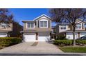 Two-story townhome with a two-car garage and well-maintained landscaping at 5058 Maxon S Ter # 108, Sanford, FL 32771
