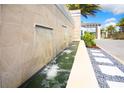 Elegant water feature with stone accents and lush landscaping creates a serene outdoor ambiance at 2621 Calistoga Ave, Kissimmee, FL 34741