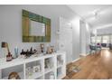 Bright entryway with hardwood floors and decorative console table at 8162 Lazy Bear Ln, Winter Park, FL 32792