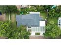 Aerial view of the property shows the home's roof, backyard play area, and expansive hardscaped parking area at 1371 Lyndale Blvd, Winter Park, FL 32789