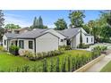 Beautiful, white home with manicured lawn and garden area, with a brick street along the front at 1371 Lyndale Blvd, Winter Park, FL 32789