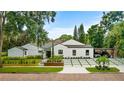 Stunning home with well-maintained landscaping, a carport and geometric, hardscaped parking in the front at 1371 Lyndale Blvd, Winter Park, FL 32789