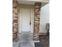 Home entrance featuring brick pillars and a white door with secure entry at 2906 Fox Squirrel Dr # 41, Kissimmee, FL 34741