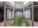 Shared entryway with brick flooring and a central plant at 3797 Atrium Dr # 3, Orlando, FL 32822