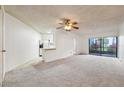 Spacious living room with carpet, ceiling fan, and kitchen bar at 3797 Atrium Dr # 3, Orlando, FL 32822