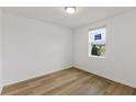 Bright bedroom with light wood laminate flooring and a window at 5161 Springrise Dr, Saint Cloud, FL 34772