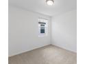 Simple bedroom with neutral-toned carpet and large window at 5174 Minneola Ln, Saint Cloud, FL 34772