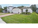 Two-story house with a brick driveway and landscaped lawn at 5186 Minneola Ln, Saint Cloud, FL 34772